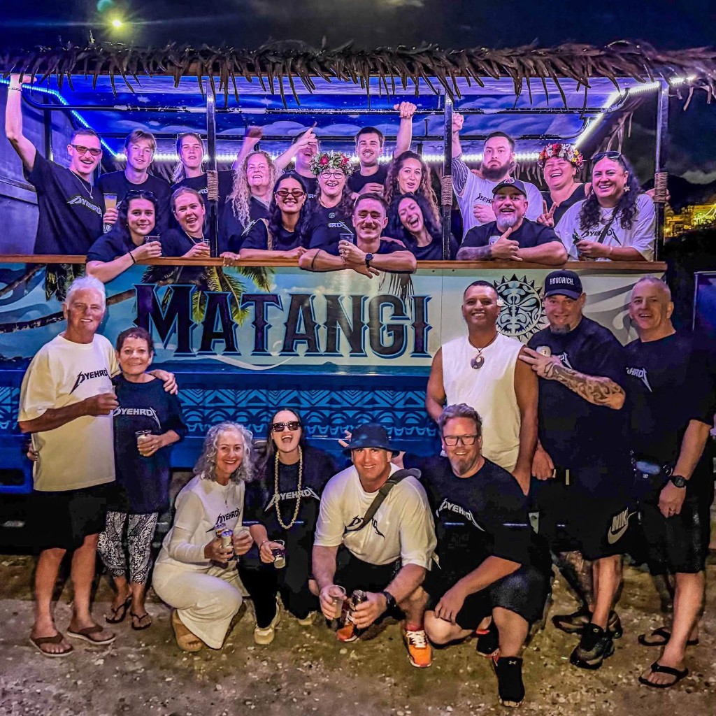 Group of guests celebrating in front of the Matangi Tours Bus